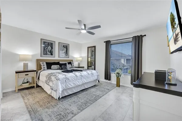 a bedroom with a large bed and a chandelier