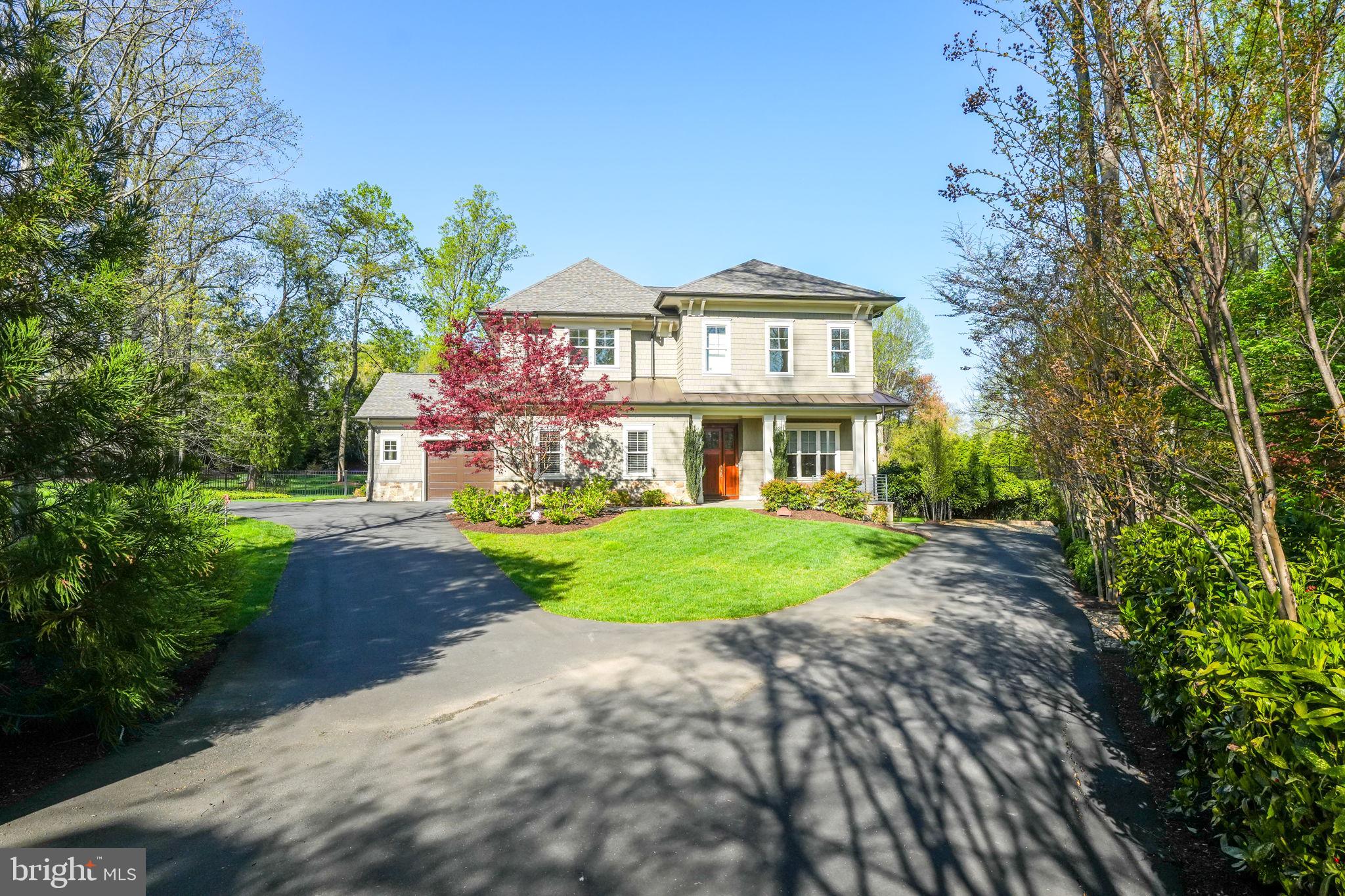 a front view of a house with a yard and shrubs