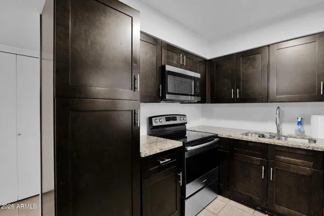 a kitchen with a sink stainless steel appliances and cabinets