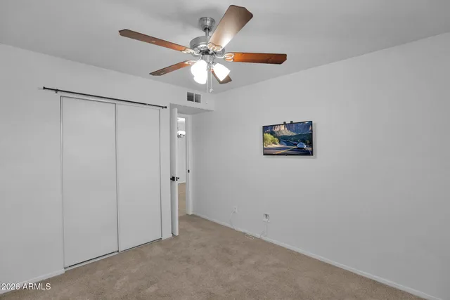 a view of a hallway with a ceiling fan