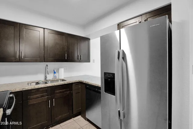 a kitchen with a sink and refrigerator