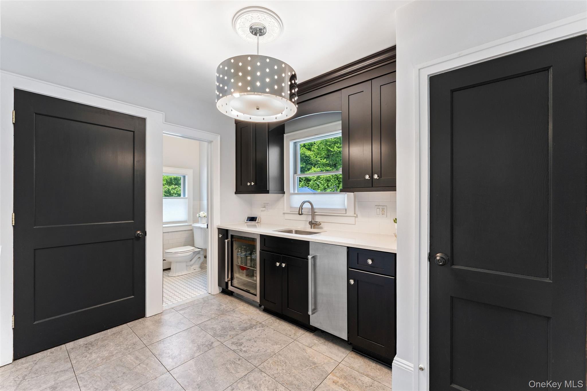 211 Strawtown Road West Nyack, NY 10994 - Photo 22 of 47 Butlers Pantry featuring a Sub Zero ice maker, beverage refrigerator, abundant storage and laundry.