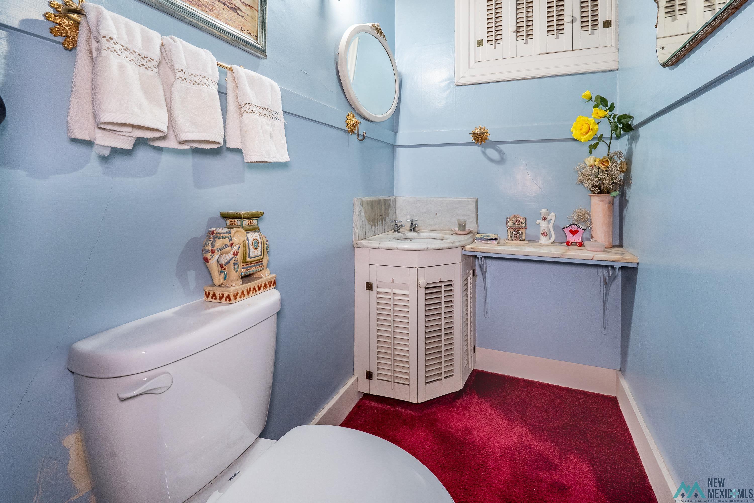 301 South 4th Street Raton, NM 87740 - Photo 33 of 78 Half bath featuring vanity and dark carpet