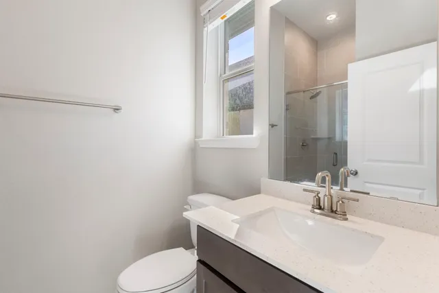 a bathroom with a sink toilet and mirror