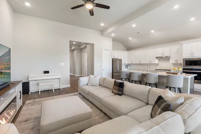 a living room with furniture and a chandelier