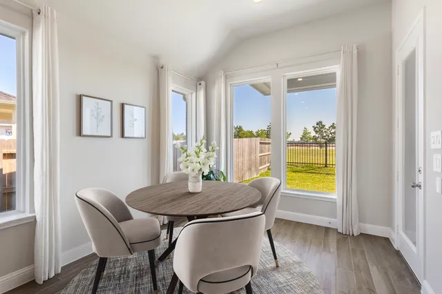 a view of a dining room with furniture and a window