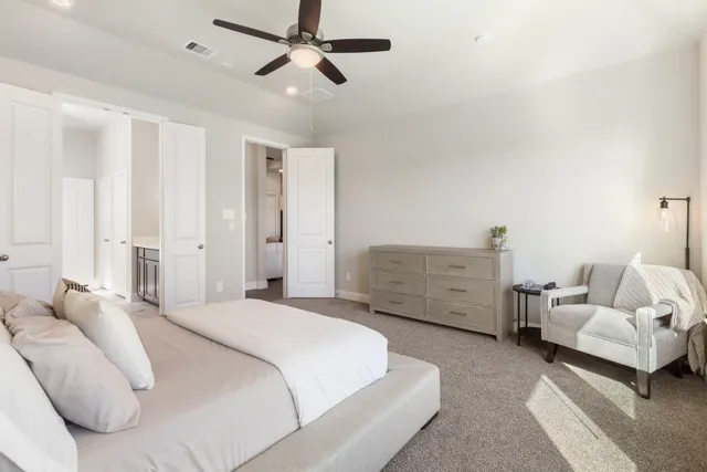 a spacious bedroom with a bed and a couch