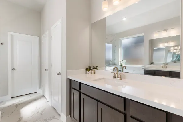 a bathroom with a double vanity sink mirror and double