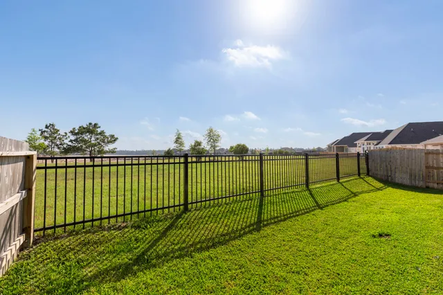 a view of a wrought iron fences in front of house