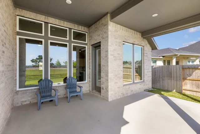 a bedroom with furniture and a large window