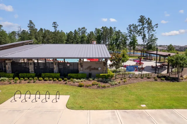 a view of swimming pool with outdoor seating and plants
