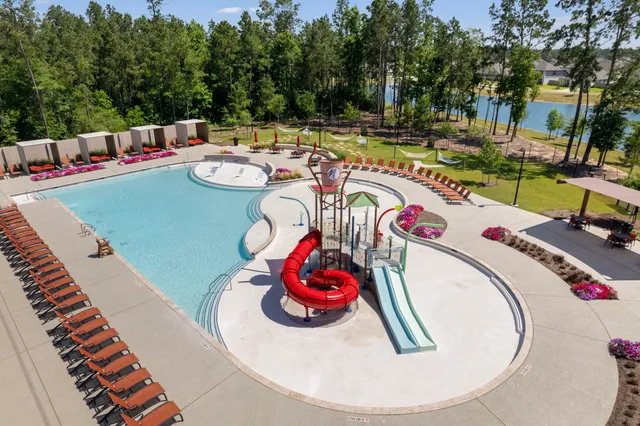 a view of a swimming pool with lounge chairs
