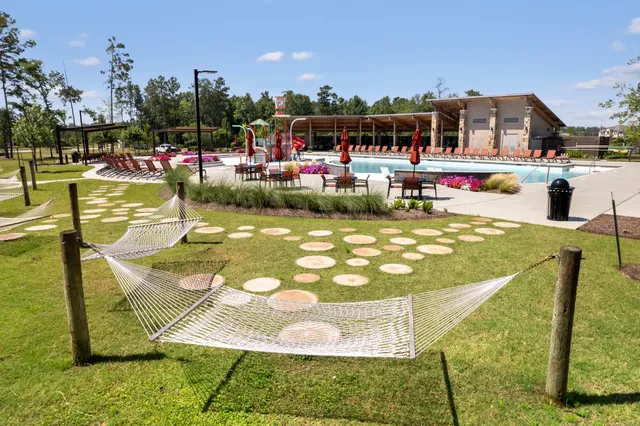 a swimming pool with outdoor seating and yard