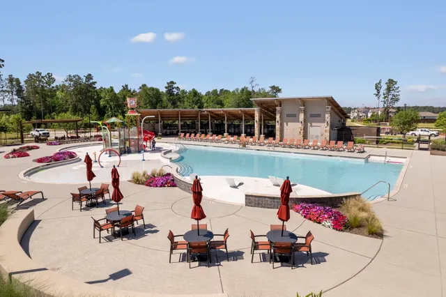 a view of a swimming pool with lounge chairs