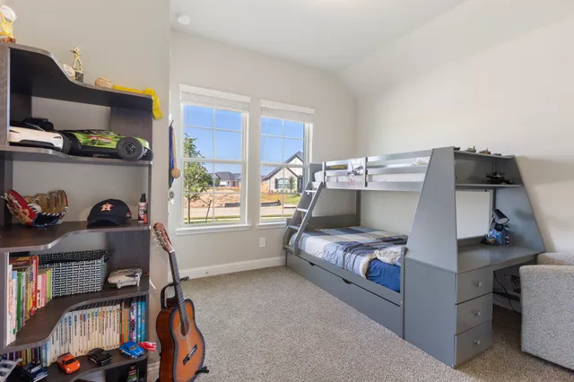 a bedroom with furniture and a window