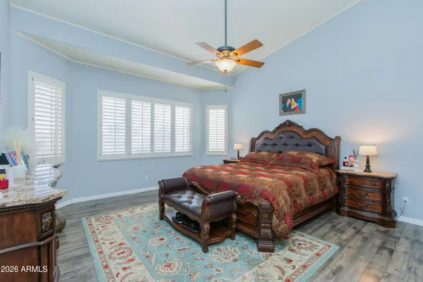 a bedroom with a bed and a chandelier