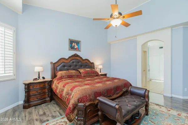 a bedroom with a bed and a chandelier