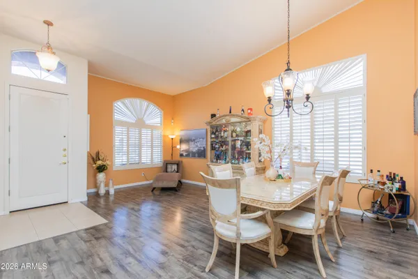 a dining room with furniture and wooden floor