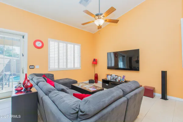 a living room with furniture and a floor to ceiling window