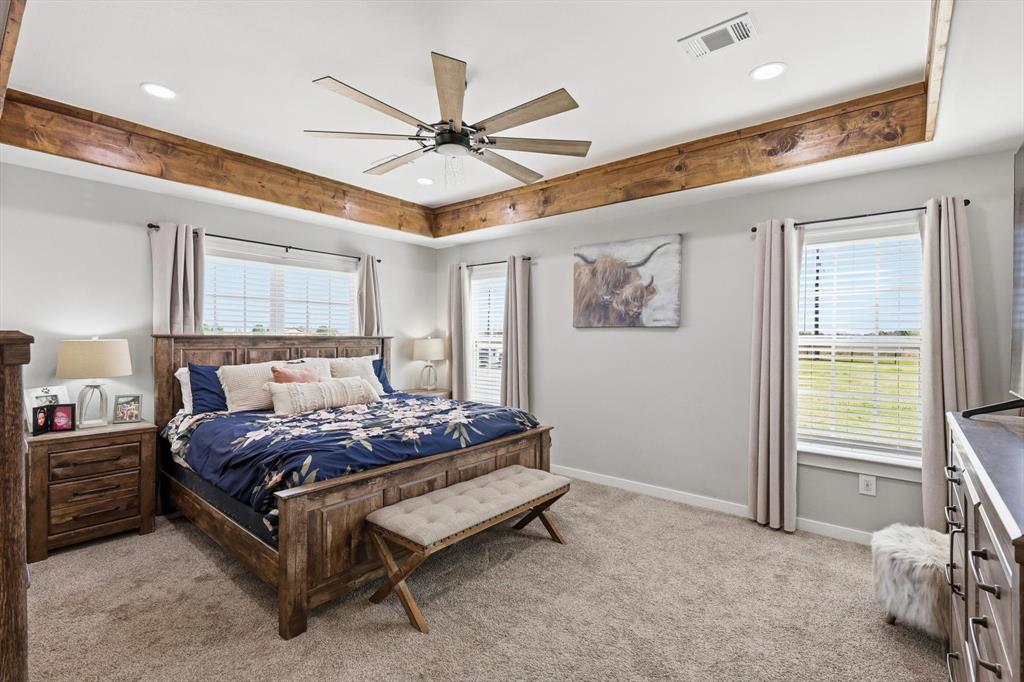 2201 South Road Whitesboro, TX 76273 - Photo 19 of 40 a bedroom with a bed chandelier and a window