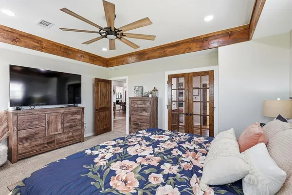 a bedroom with furniture and a flat screen tv