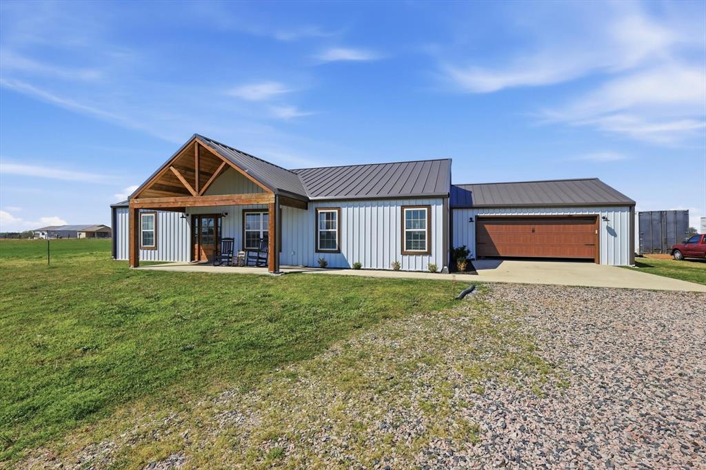 2201 South Road Whitesboro, TX 76273 - Photo 2 of 40 a front view of a house with a yard and garage