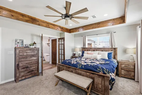 a bed room with a bed and a ceiling fan