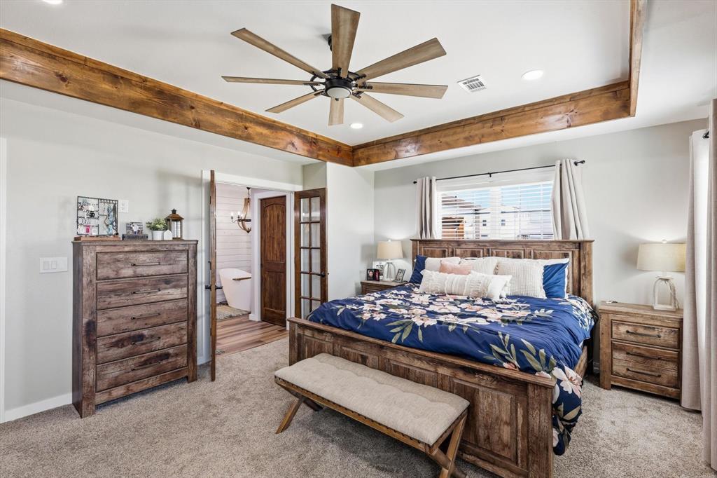 2201 South Road Whitesboro, TX 76273 - Photo 21 of 40 a bed room with a bed and a ceiling fan