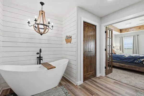 a bathroom with a bathtub and a shower