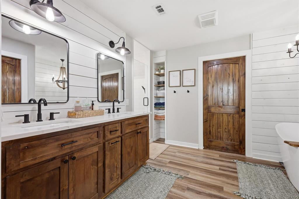 2201 South Road Whitesboro, TX 76273 - Photo 25 of 40 a spacious bathroom with a double vanity sink a large mirror and a shower