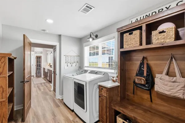 a view of a kitchen area with furniture and wooden floor