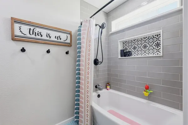 a bathroom with a bathtub and a shower
