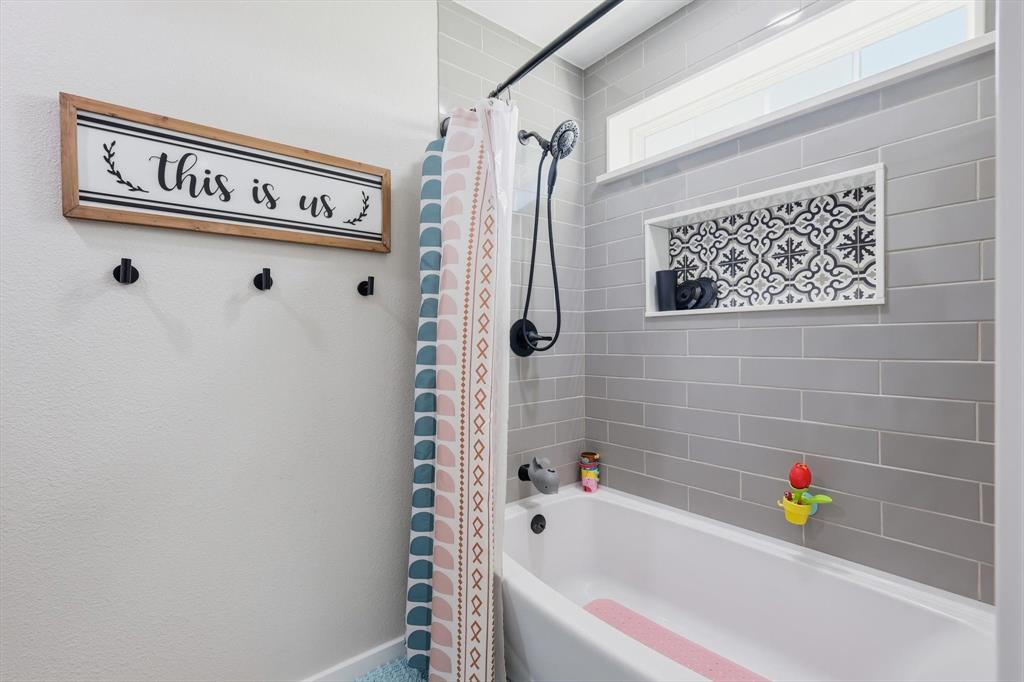 2201 South Road Whitesboro, TX 76273 - Photo 32 of 40 a bathroom with a bathtub and a shower