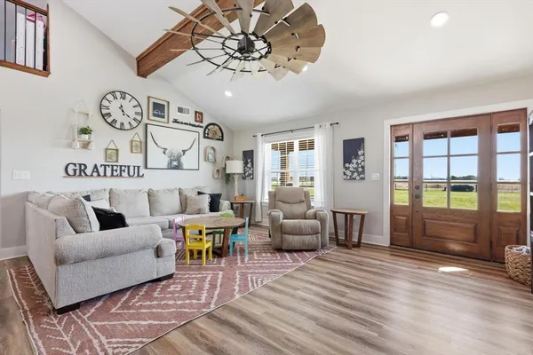 a living room with furniture and wooden floor