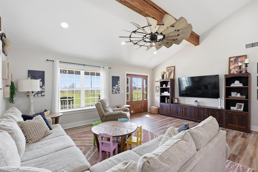 2201 South Road Whitesboro, TX 76273 - Photo 8 of 40 a living room with furniture a flat screen tv and a large window
