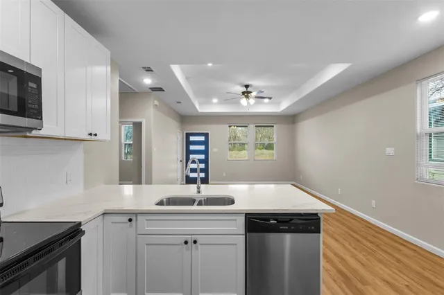 a kitchen with stainless steel appliances a stove sink and cabinets