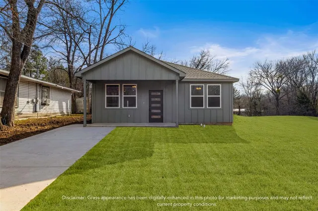 a front view of house with yard and green space