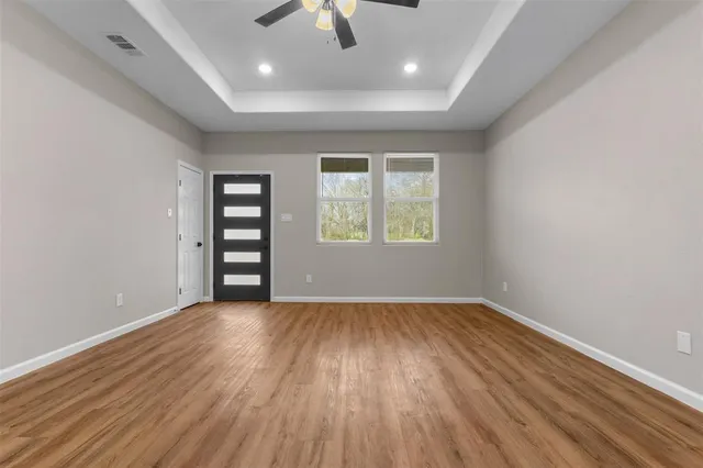 wooden floor in an empty room with a window