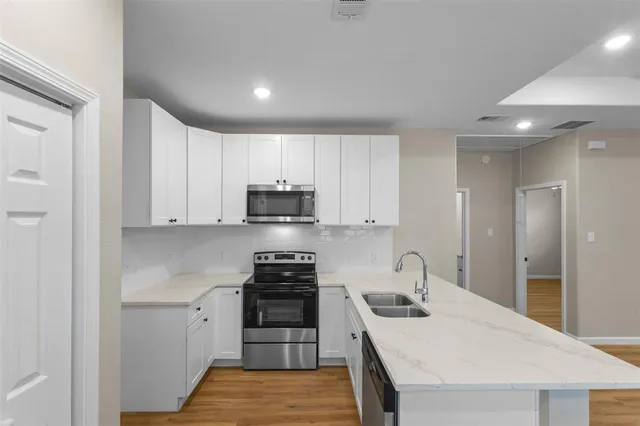 a kitchen with stainless steel appliances granite countertop a stove and a sink