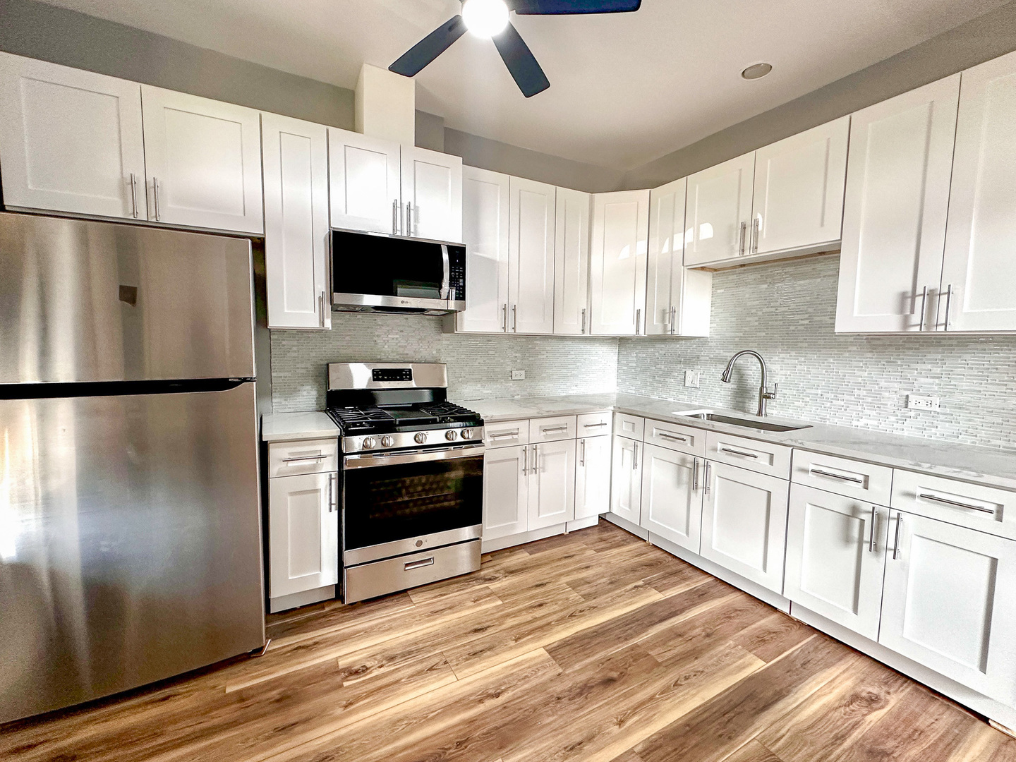 1238 South Spaulding Avenue, Unit 3 Chicago, IL 60623 - Photo 2 of 8 a kitchen with a refrigerator stove and microwave