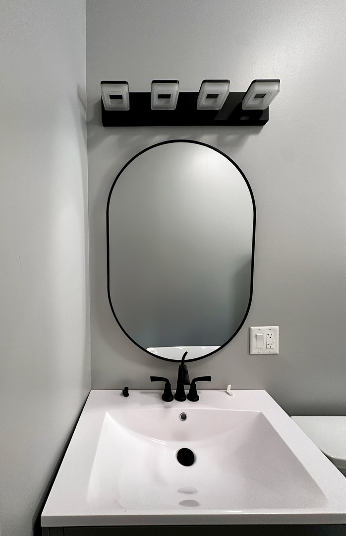 1238 South Spaulding Avenue, Unit 3 Chicago, IL 60623 - Photo 5 of 8 a bathroom with a sink and mirror