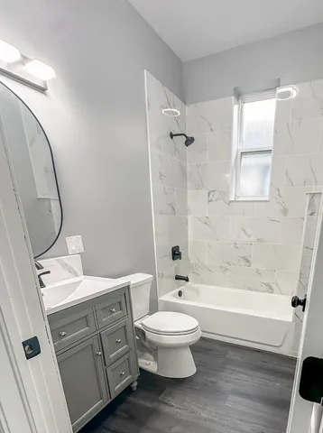 a bathroom with a toilet a sink and bathtub