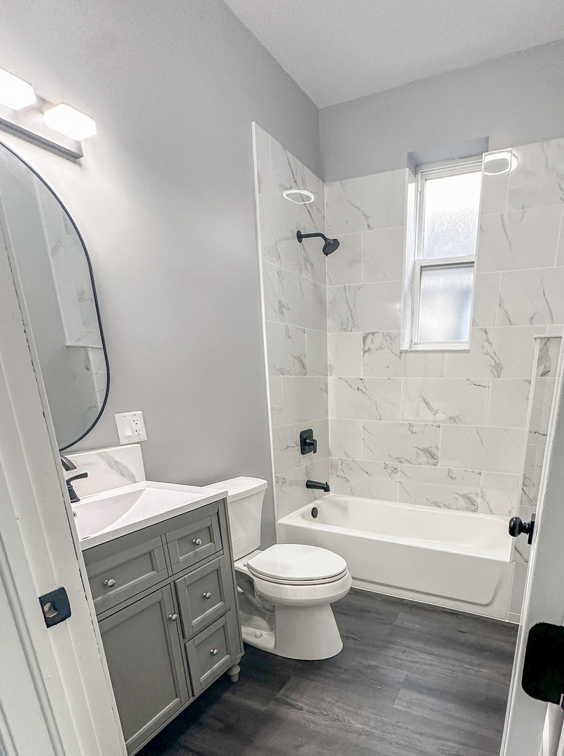 1238 South Spaulding Avenue, Unit 3 Chicago, IL 60623 - Photo 6 of 8 a bathroom with a toilet a sink and bathtub