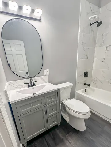 a bathroom with a toilet a sink and bathtub