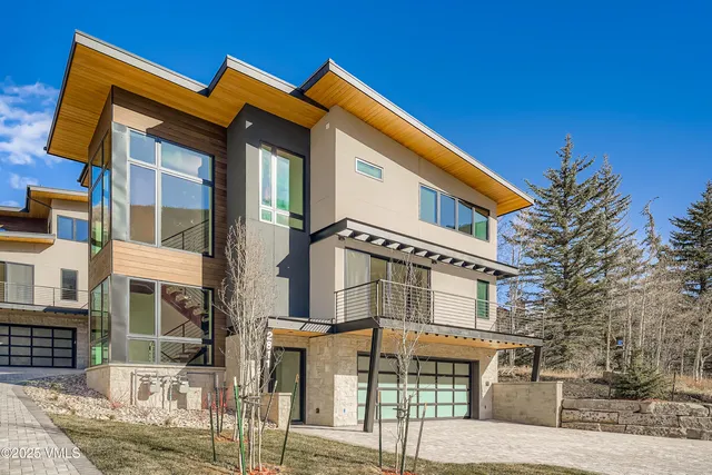 a front view of a residential apartment building with a yard