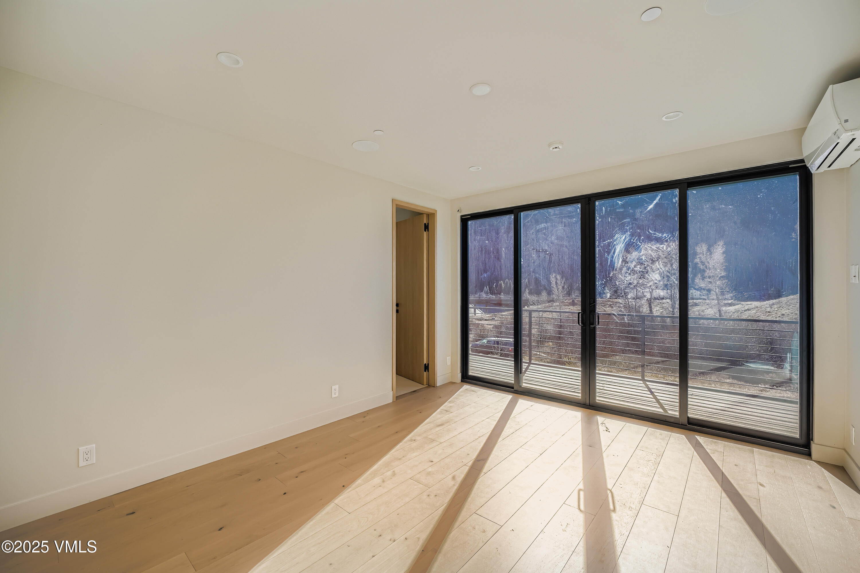 2811 Bald Mountain Road Vail, CO 81657 - Photo 22 of 55 a view of a room with wooden floor and windows