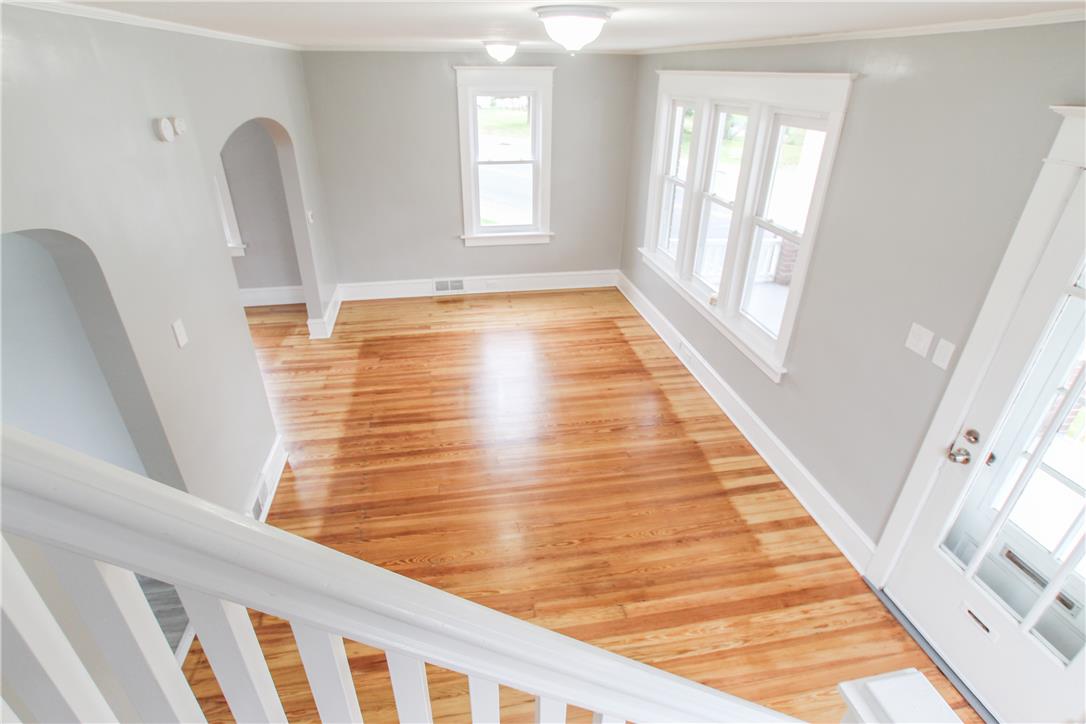 933 Philadelphia Road Easton, PA 18042 - Photo 12 of 23 Classic hardwood flooring stretches across this open living space highlighted by elegant arched doorways.