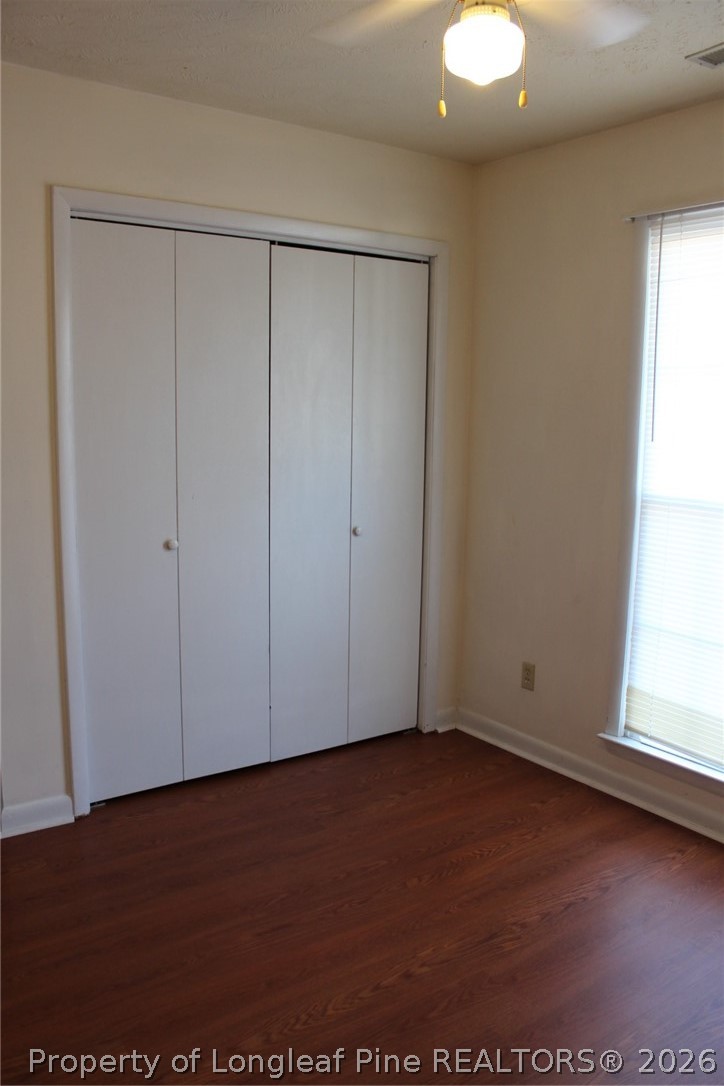 7805 Gallant Ridge Drive Fayetteville, NC 28314 - Photo 21 of 25 an empty room with wooden floor and windows