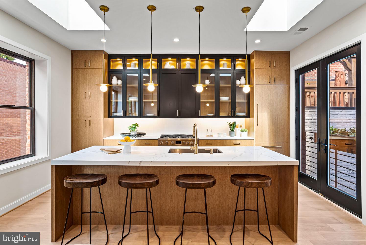 a kitchen with a counter space a sink and a large window