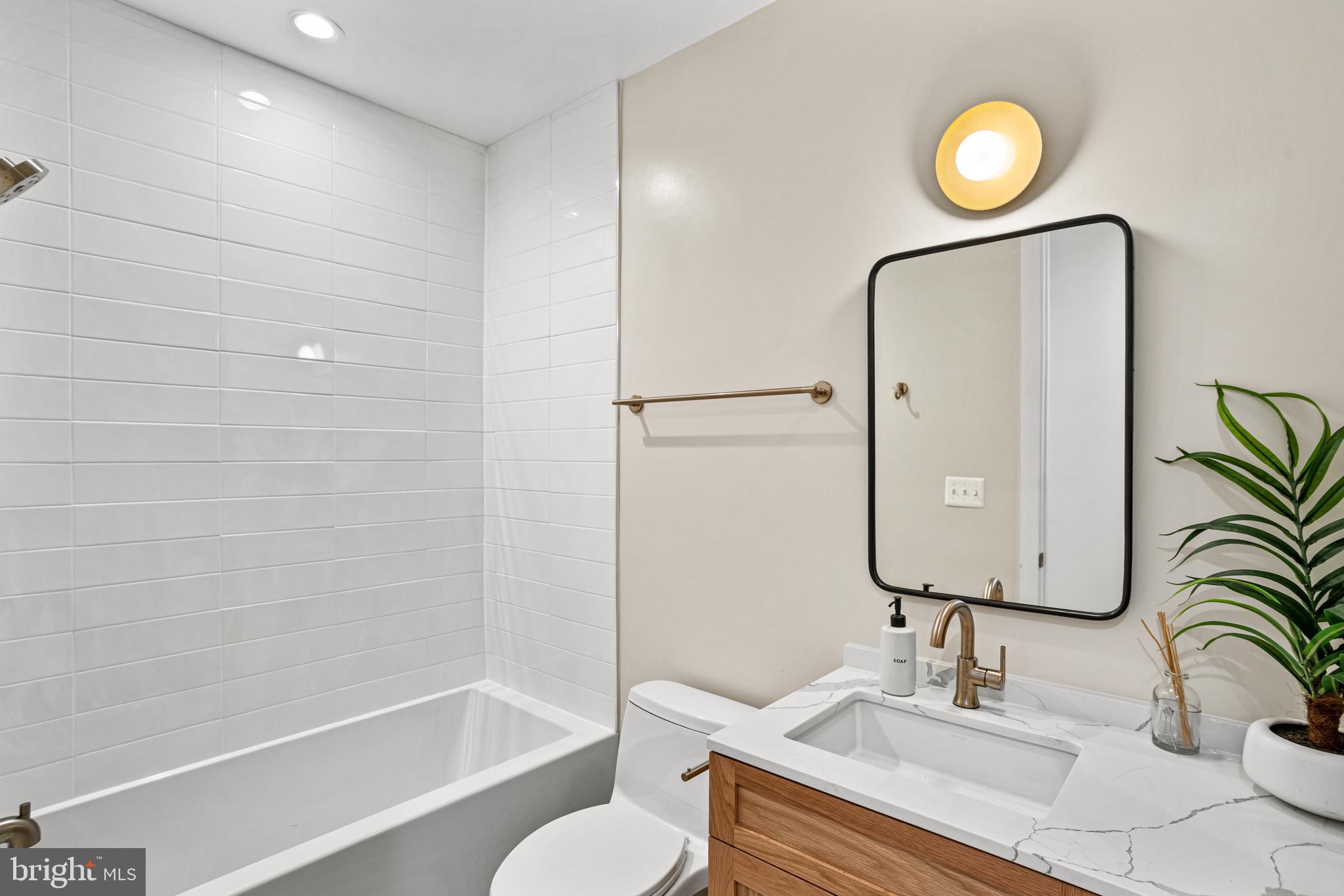 1402 12th Street Northwest, Unit 10 Washington, DC 20005 - Photo 22 of 38 a bathroom with a granite countertop sink toilet and shower